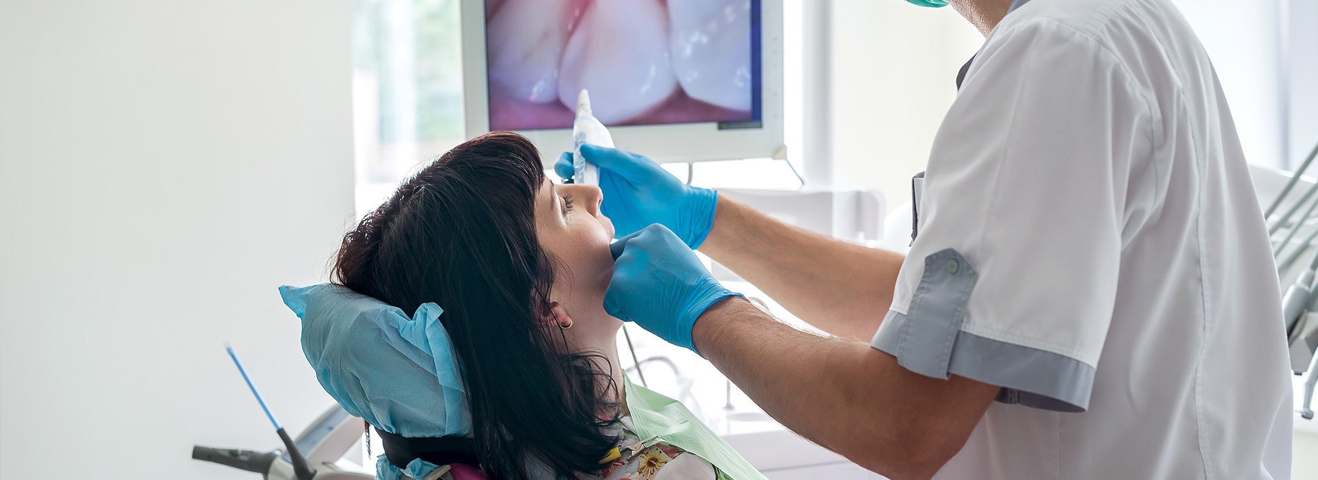 A dental professional performing oral care on a patient s teeth.